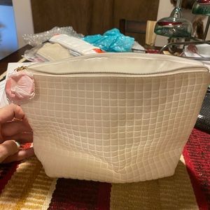 White lined makeup bag lined with zippered top